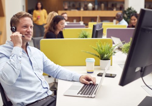 businessman-wearing-headset-talking-to-caller-in-b-2021-12-09-06-51-00-utc-scaled.jpg